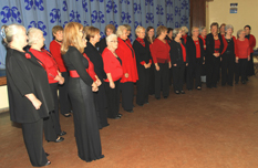 The whole choir in performance costumes seen from the side.
